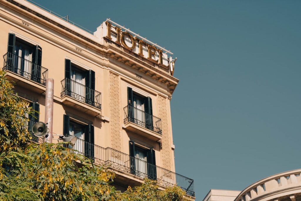 A welcoming hotel lobby with stylish décor, comfortable seating, and a front desk attended by a hospitality worker.
