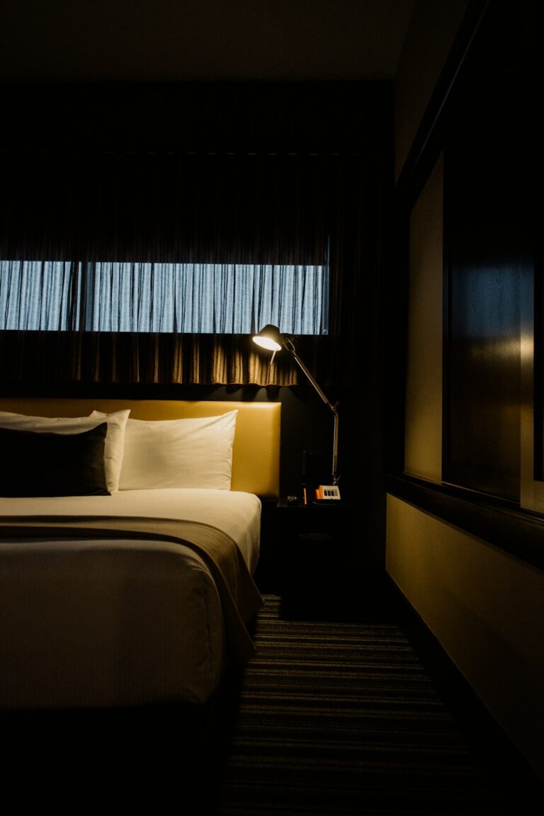 Solo traveler checking a hotel door lock while keeping a phone and key card nearby